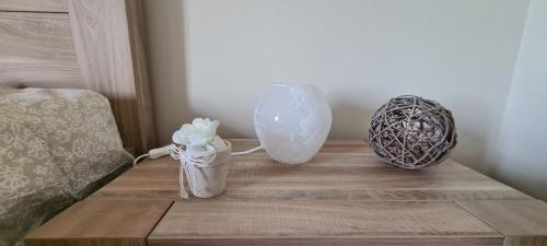 a table with two vases and a vase on it at L'Antre Parenthèse de Sainte-Cécile in Florenville