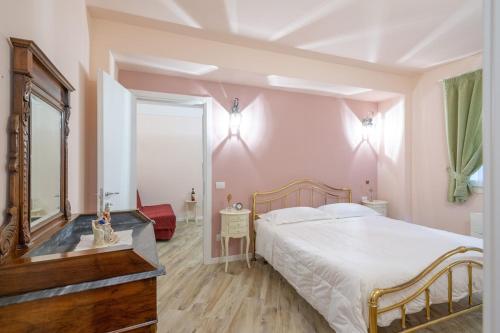 a bedroom with a large bed and a mirror at Residenza dei Piaceri Perduti-Rosa in Lastra a Signa