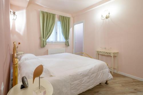 a bedroom with a large white bed and a window at Residenza dei Piaceri Perduti-Rosa in Lastra a Signa