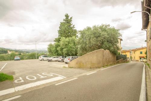 a street with cars parked in a parking lot at Residenza dei Piaceri Perduti-Rosa in Lastra a Signa