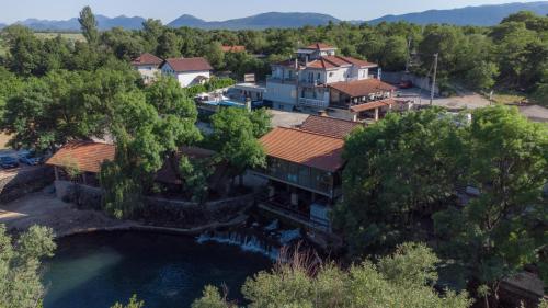 an aerial view of a house with a pond at Adria centar Koćuša in Ljubuški