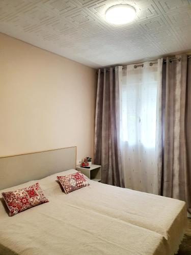 a bedroom with a bed with two pillows on it at Apartamento Luz in Valencia