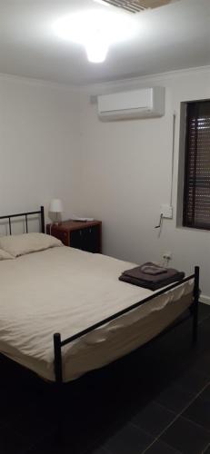 a bedroom with a bed in a room at Cartledge Ave house accommodation Whyalla in Whyalla