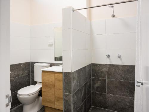 a bathroom with a toilet and a shower at Inala Hotel in Brisbane
