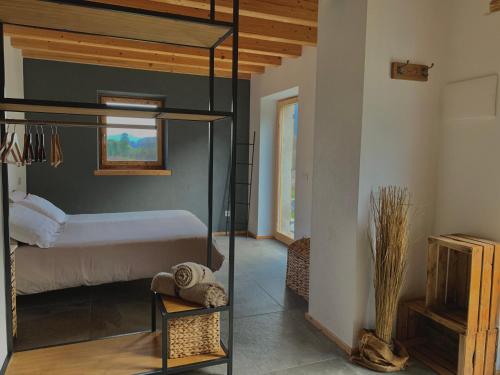 a bedroom with a bunk bed and a room with a bed at Dimora Natura-Riserva Naturale Valle di Bondo in Tremosine Sul Garda