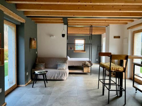 a living room with a couch and a bed at Dimora Natura-Riserva Naturale Valle di Bondo in Tremosine Sul Garda