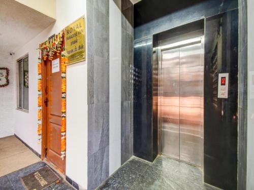 a hallway with a metal elevator in a building at HOTEL ROYAL PARADISE in Coimbatore