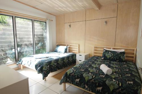 a bedroom with two beds and a window at The Jetty at Cowan Cowan in Cowan Cowan