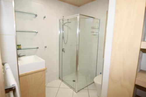 a bathroom with a shower and a toilet and a sink at The Jetty at Cowan Cowan in Cowan Cowan