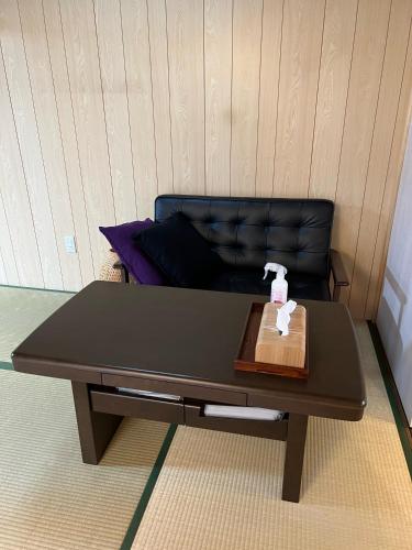 a coffee table in a room with a couch at Kyoto Osaka SUMIREYA in Takatuki