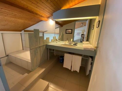 ein Badezimmer mit Waschbecken und Spiegel in der Unterkunft Duplex pour 6 avec vue océan, balcon et garage privatif - FR-1-494-131 in Royan