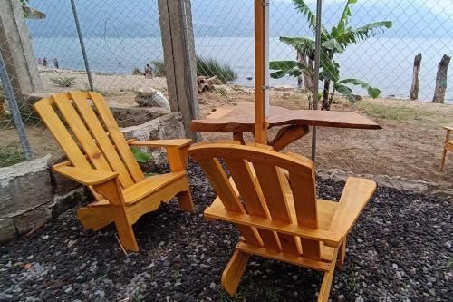 two chairs and a table and a table and a table and chairs at Tipis Ya' in San Pedro La Laguna