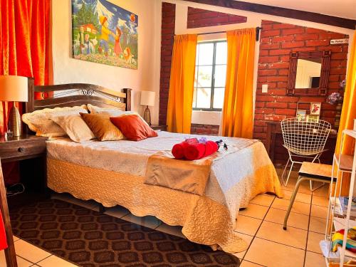 a bedroom with a bed with a red stuffed animal on it at Casa Heidi, Apaneca in Apaneca