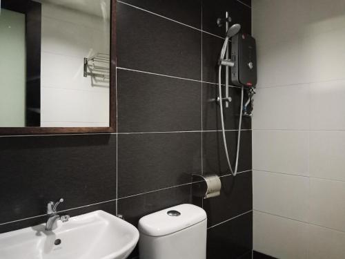 a bathroom with a shower and a toilet and a sink at 906 Riverside Hotel Malacca in Malacca