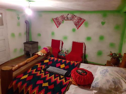 a room with a bed with a colorful blanket on it at Room in Guest room - Cozy Sejour Near Forest for 2 people in Roşia Montană
