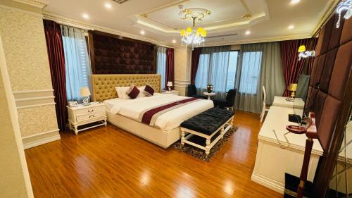 a hotel room with a bed and a desk and a room at Le Indochina Hotel in Bắc Ninh