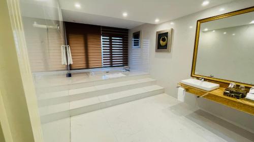 a bathroom with a shower and a sink and a mirror at Le Indochina Hotel in Bắc Ninh