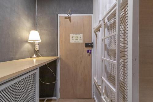 a room with a door with a lamp and a desk at On the Bed Hostel in Bangkok