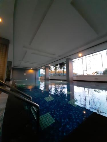 an empty room with a pool of water in a building at Cozy The H Residence Cawang by Bonzela Property in Jakarta