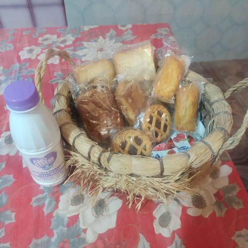 a basket of cheese and a bottle of water on a table at B&B Villa Sabrina in Sonnino