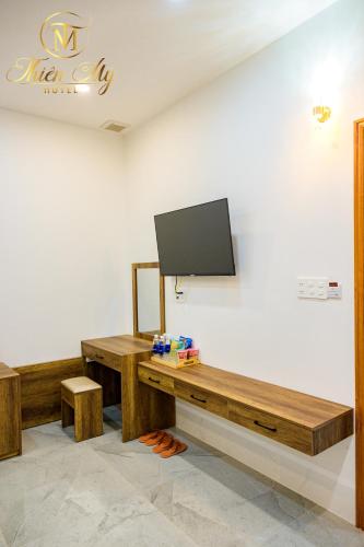 a living room with a television on a wall at Khách Sạn Thiên Mỹ in Rach Gia