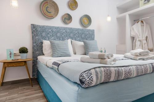 a bedroom with a blue and white bed with pillows at Korali Boutique Hotel in Naxos Chora