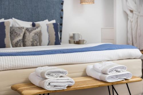 a bed with white towels on a wooden shelf at Korali Hotel in Naxos Chora