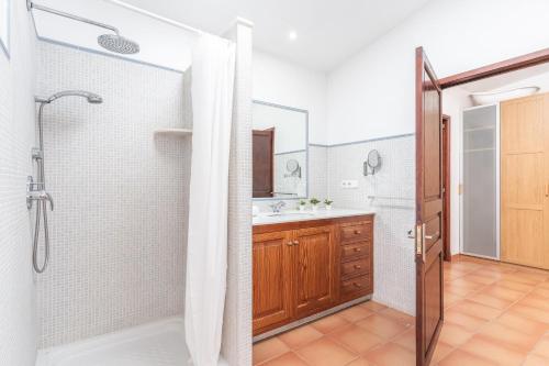 a bathroom with a shower and a sink at Cas Pobres in Sóller