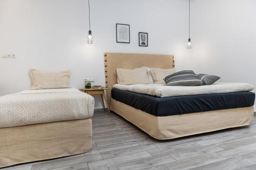 two beds sitting next to each other in a room at Korali Hotel in Naxos Chora