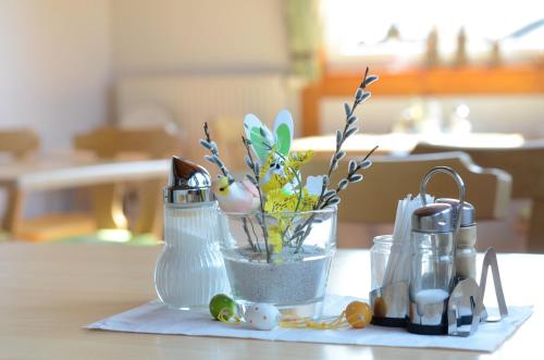 a vase with eggs and other items on a table at Gästehaus Christa **** in Leibnitz