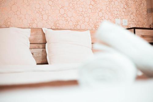 a bedroom with a bed with white pillows at Reikartz Kokand in Kokand