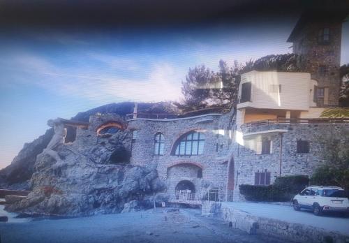 a building with a car parked in front of it at Palme CloseToGigante Junior Suites in Monterosso al Mare