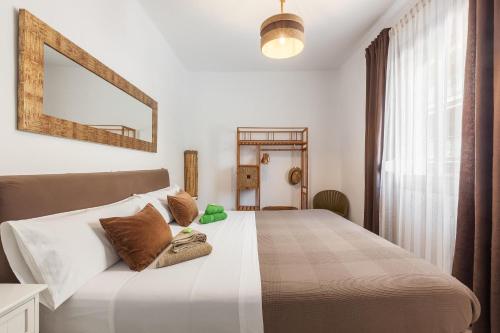a bedroom with a large bed with a mirror on the wall at Boutique Beach Mataró in Mataró