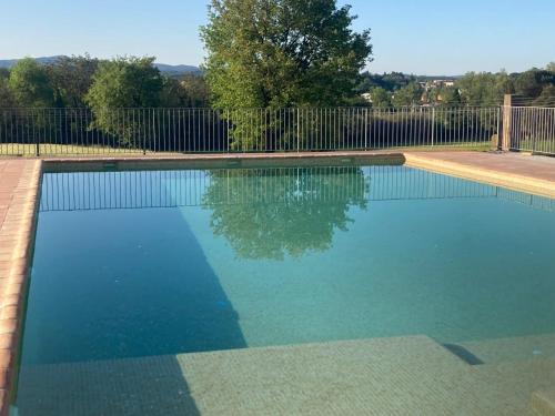 a swimming pool in a yard with a fence at Mas Teixidor, Masia entre Girona y la Costa Brava in Caldes de Malavella