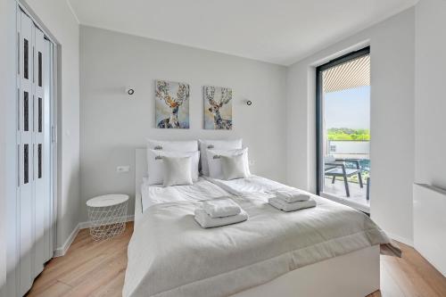 Posteľ alebo postele v izbe v ubytovaní Tarasy Bałtyku Sea Side, Sauna & Gym by Downtown Apartments