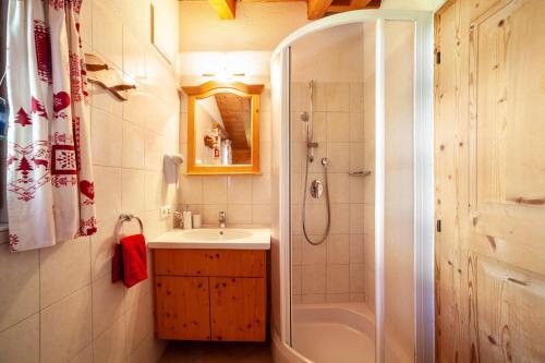 a bathroom with a shower and a sink and a tub at Hof am Schloss Apartement Lärche in Montechiaro