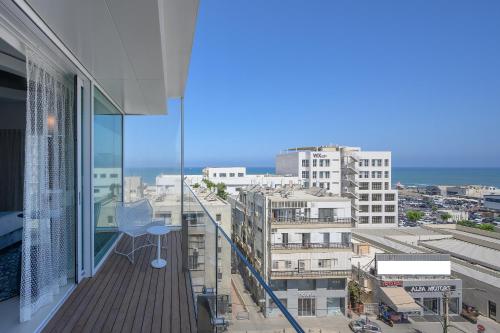 a balcony with a view of a city at Port Tower by Isrotel Design in Tel Aviv