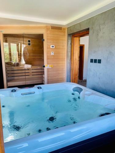 a large bath tub in a bathroom with a shower at Chalupa pod Ořechem in Rokytnice nad Jizerou