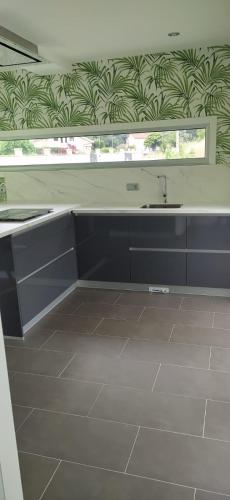 a kitchen with a sink and a window at La casa de Cristal in Goyán