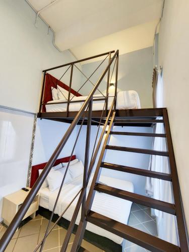 a bunk bed in a room with a ladder at Mac Hotel by Sky Hive in George Town
