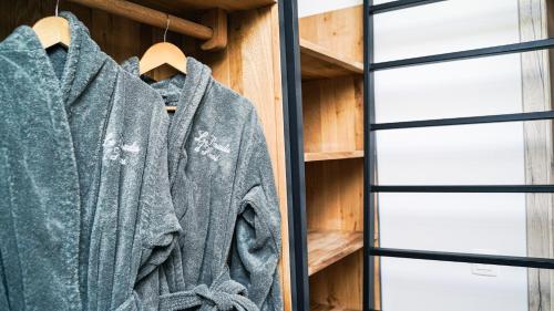 a sweater hanging on a rack next to a window at Le Paradis d'Henri in Hannut
