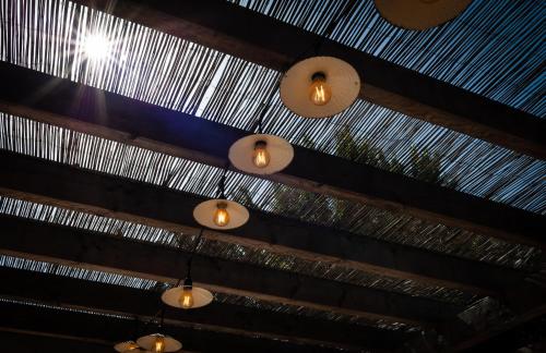 a row of lights hanging from a wooden ceiling at Campanile Beaune in Beaune