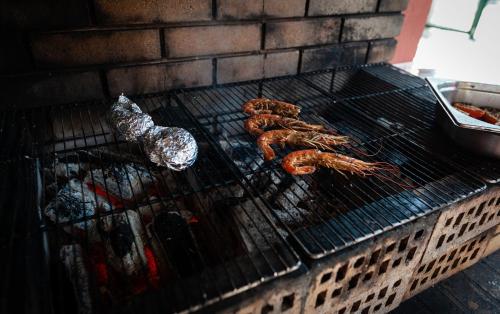 a grill with some food cooking on it at Campanile Beaune in Beaune
