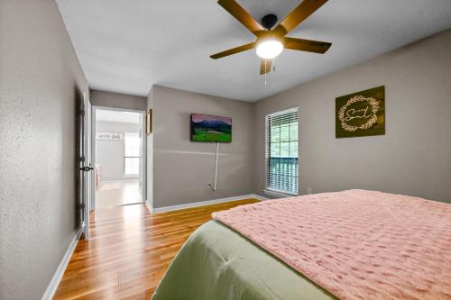 a bedroom with a bed and a ceiling fan at Private Mountain Cabin, hot tub escape in the Smokies, with THE view in Sevierville