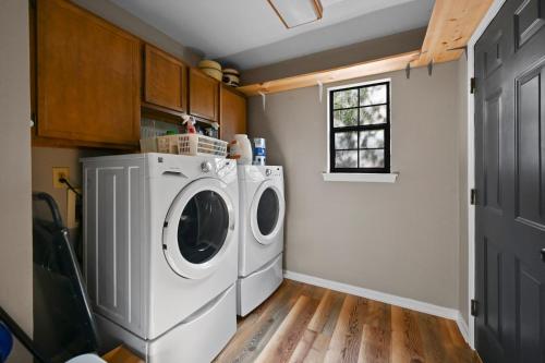 a laundry room with a washing machine and a window at Private Mountain Cabin, hot tub escape in the Smokies, with THE view in Sevierville