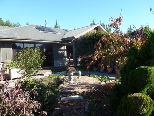 a house with a garden with a fountain in the yard at Redwood Valley B & B in Richmond