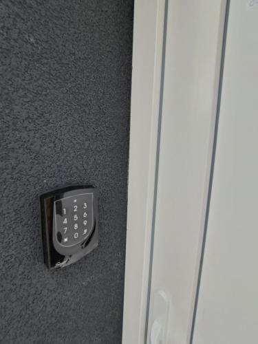 a remote control sitting on the floor next to a door at Villa Field6 in Révfülöp