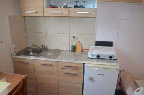 a small kitchen with a sink and a counter at Nick Apartment in Zakynthos