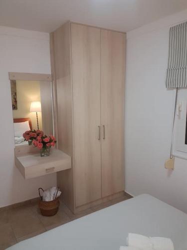 a bathroom with a sink and a cabinet with a mirror at Amalthia in Sitia