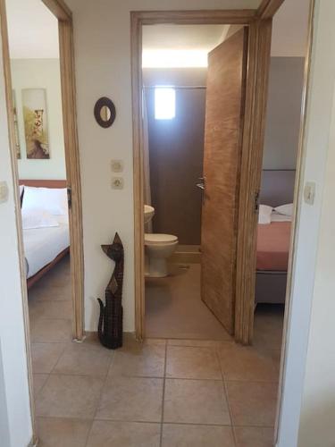 a bathroom with a cat standing in a hallway at Amalthia in Sitia
